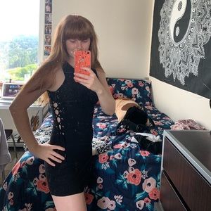 Black form fitting dress, laced up on the sides